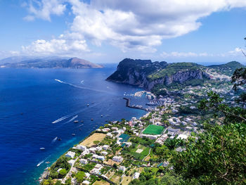 High angle view of city by sea against sky