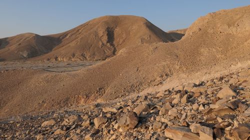 Scenic view of arid desert against blue sky