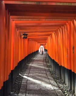 Rear view of man walking at inari shrine