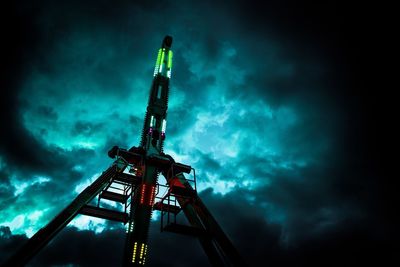 Low angle view of illuminated tower against sky at night