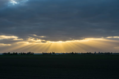 Scenic view of field against sky during sunset