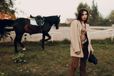 Side view of young woman standing on field