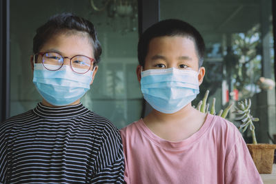 Portrait of siblings wearing masks