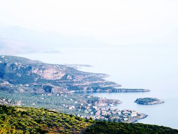 High angle view of sea and mountains against sky