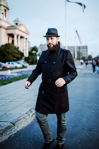 Portrait of young man standing in city