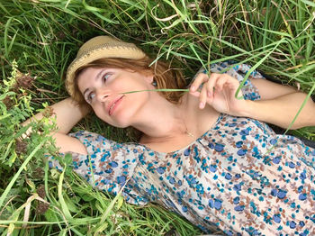 Portrait of young woman lying on grass