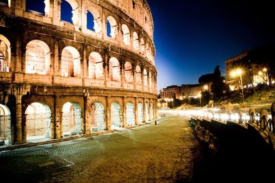 Arch in city against sky at night