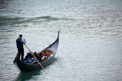 Rear view of boating in rippled water