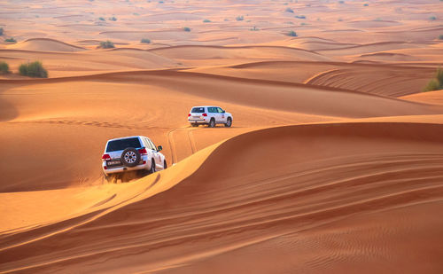 High angle view of off-road vehicles on sand dunes