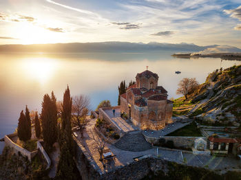 Panoramic view of temple and building against sky during sunset