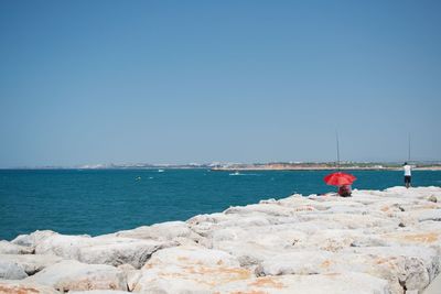 Scenic view of sea against clear blue sky