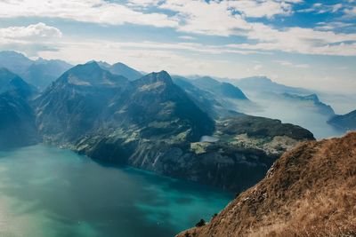 Scenic view of lake and mountains against sky