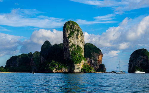 Panoramic view of rocks and sea against sky