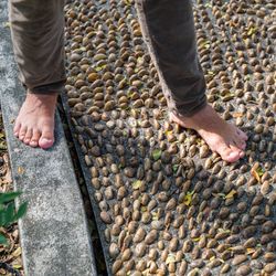 Low section of man standing on footpath