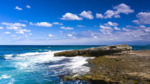 Scenic view of sea against blue sky