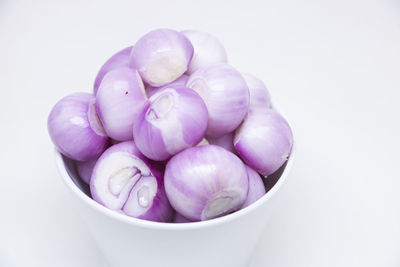 High angle view of grapes in bowl against white background