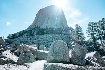 Low angle view of rocks against sky on sunny day