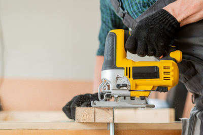 Midsection of man working in workshop