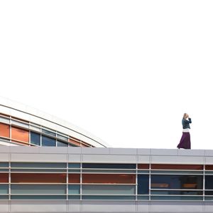 Low angle view of woman standing against built structure