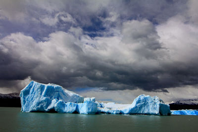 Scenic view of lake against sky during winter