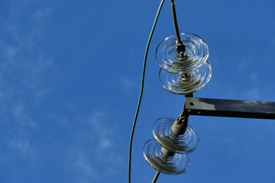 Low angle view of electric light against blue sky