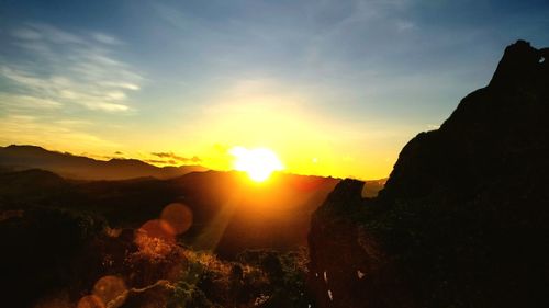 Scenic view of silhouette mountains against sky during sunset