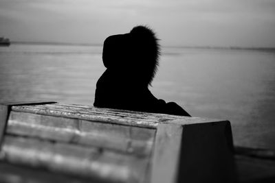 Close-up of silhouette person on beach against sky