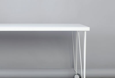 Close-up of white table against wall at home