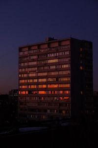 Low angle view of illuminated building against sky at dusk