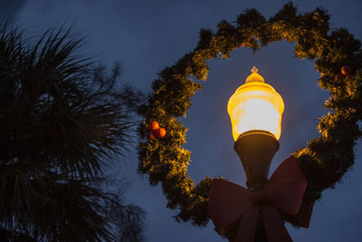 Low angle view of trees against blue sky