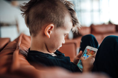 Portrait of boy using mobile phone