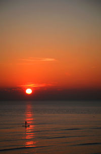 Scenic view of sea against orange sky