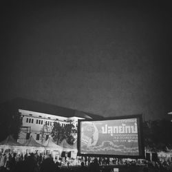 Group of people in front of building at night