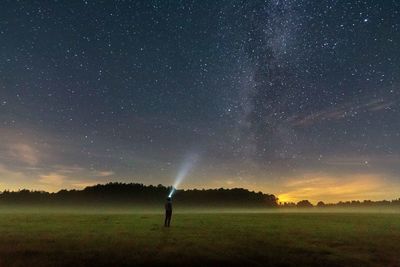 Scenic view of field against sky at night