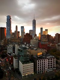 View of cityscape against cloudy sky