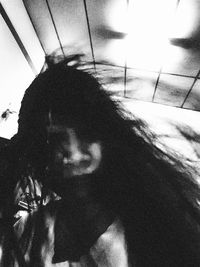 Close-up portrait of young woman at home