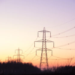 Low angle view of electricity pylon against clear sky