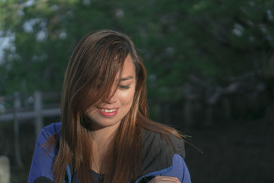 Portrait of smiling young woman outdoors