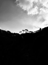 Low angle view of silhouette trees against sky