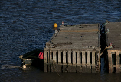 High angle view of wooden post on pier over sea