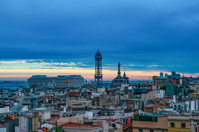 High angle view of city buildings against cloudy sky, barcelona
