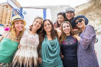 Portrait of cheerful female friends standing outdoors