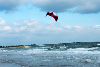 Person kitesurfing on sea