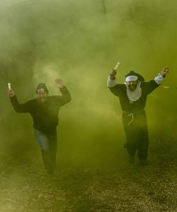 Men smoking on green grass