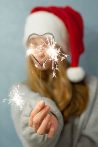 Midsection of woman holding christmas decoration