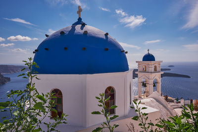 Anastasis church with its blue dome and tower in imerovigli village, santorini, greece