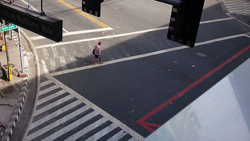 High angle view of woman crossing road