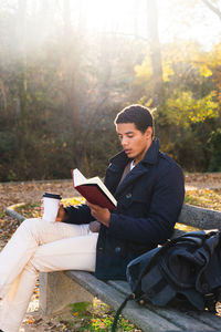 Young man sitting on seat