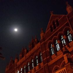 Low angle view of illuminated building against sky