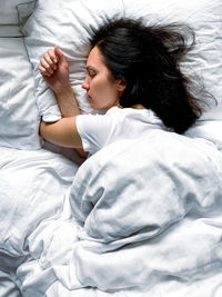 Young woman sleeping on bed